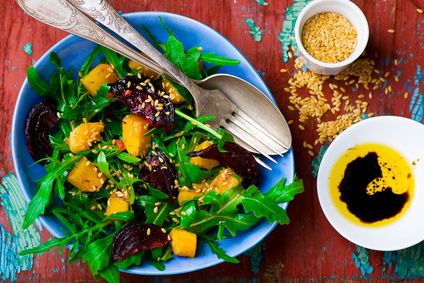 vegetable salad with pumpkin, beet, arugula . vegetable salad with pumpkin, beet, arugula and a flax seed. top view. selective focus